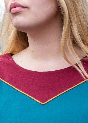 Détail de l’encolure bleu pétrole avec empiècement contrasté et passepoil rembourré