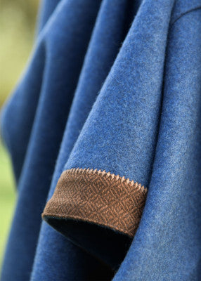 Détail du poignet et de l’encolure de la robe viking Lykka bleue avec tissage losangé brun