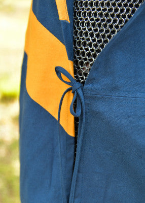 Détail du lien latéral du tabard bleu et jaune porté sur cotte de mailles pour reconstitution, GN et LARP